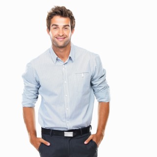 Portrait of confident business man standing with hands in pockets. Photo: momentimages