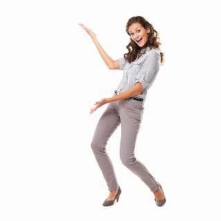 Studio shot of young smiling woman presenting copyspace. Photo: momentimages