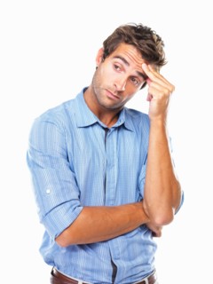 Studio portrait of business man rubbing forehead and looking away. Photo : momentimages