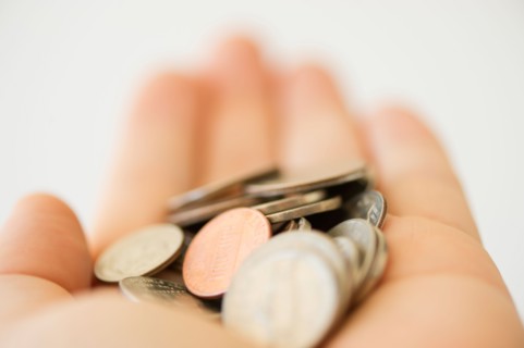 Hand holding coins.