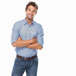 Studio shot of young confident man smiling. Photo: momentimages