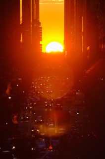 USA, New York, New York City, Sunset illuminating busy street.