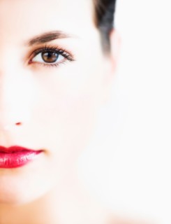 Studio portrait of young woman with red lips.