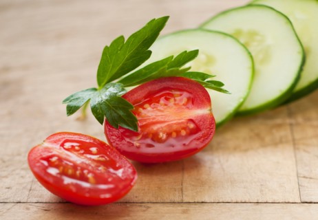 Fresh tomatoes and cucumber with herb.