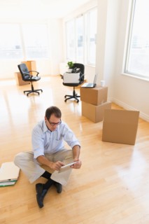 Businessman using tablet in new office.