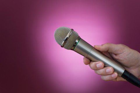 Hand holding microphone.