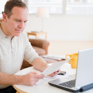 Man doing paperwork. Photo : Jamie Grill