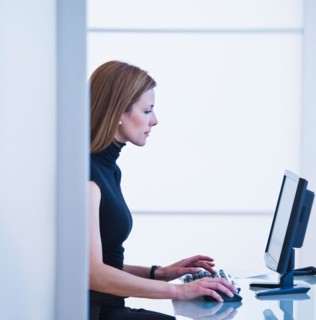 Young woman working in office. Photo: Daniel Grill