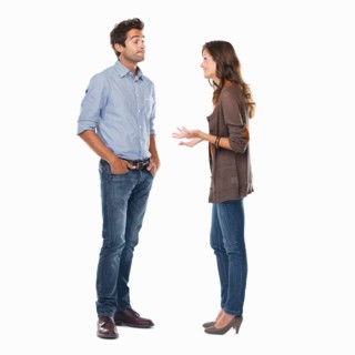 Studio shot of young couple having conversation. Photo: momentimages