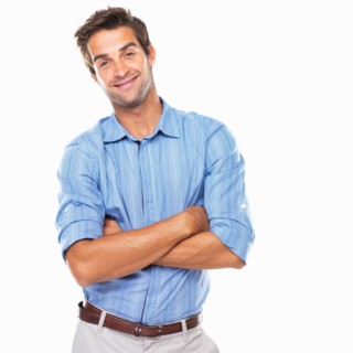 Portrait of young business man standing with hands folded and smiling. Photo : momentimages