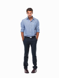 Worried executive standing with hands in pockets against white background. Photo : momentimages