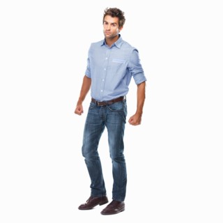 Studio shot of young man ready to fight standing on white background. Photo: momentimages