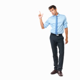Studio shot of business man pointing upwards. Photo : momentimages