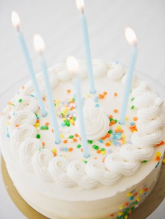 Close up of birthday cake with birthday candles. Photo : Jamie Grill