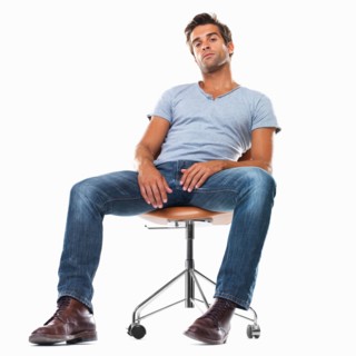 Portrait of smart young man sitting comfortably on chair against white background. Photo :