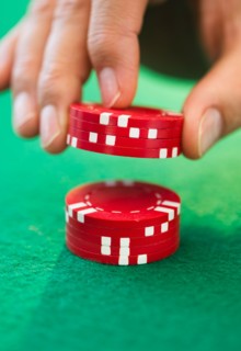 Hand handling gambling chips.