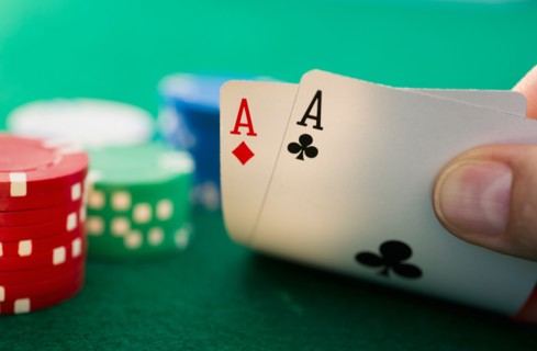 Hand holding playing cards.