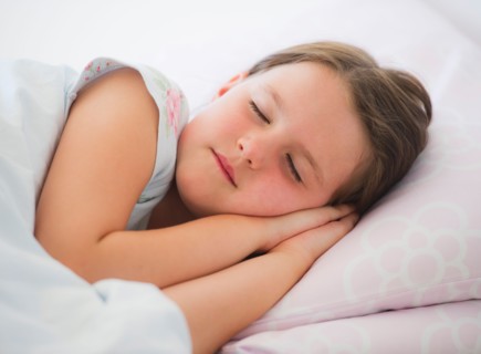 Close up of girl (6-7) sleeping in bed. Photo : Daniel Grill