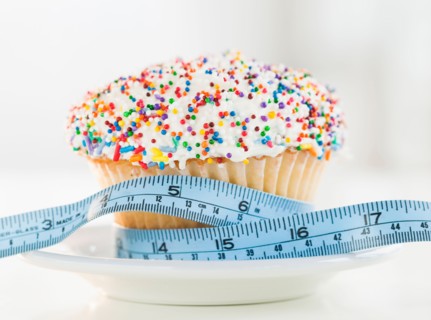 Close up of cupcake with measuring tape. Photo : Jamie Grill