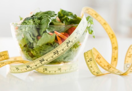 Bowl of salad and tape measure. Photo: Jamie Grill