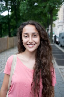 USA, New York, New York City, Portrait of smiling young woman standing on street. Photo : Winslow