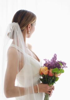 Bride holding floral bouquet.