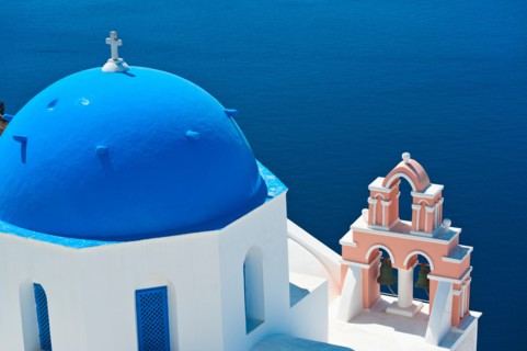 Greece, Cyclades Islands, Santorini, Oia, Church with bell tower by sea.