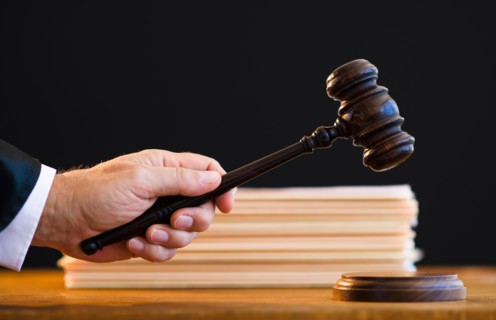 Judge holding gavel, close-up.