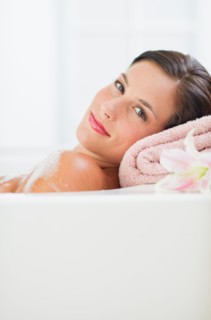 Young woman taking bath.