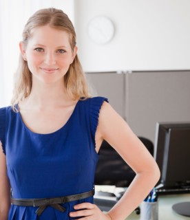 Portrait of young woman in office. Photo : Jamie Grill