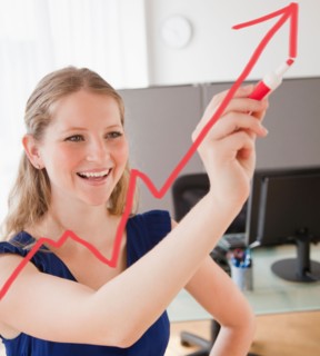 Young woman drawing increasing line with arrow. Photo : Jamie Grill