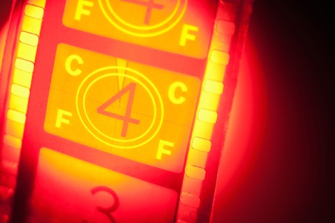 Film reel in spotlight.