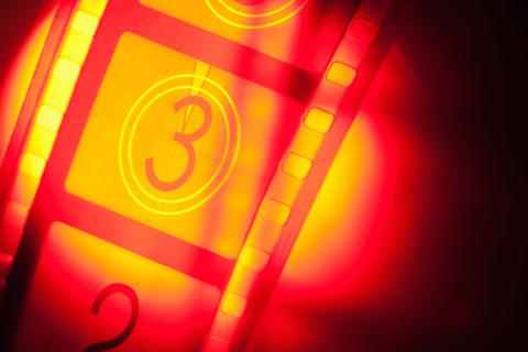 Film reel in spotlight.