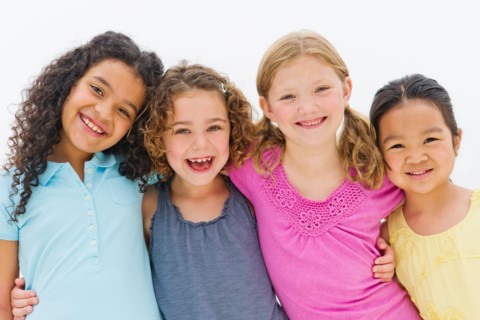 Studio portrait of embracing girls (6-7,8-9).