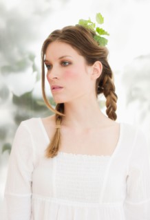 Young woman with leaves in hair.