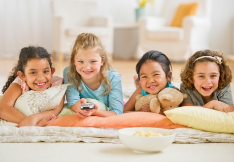 Portrait of girls (6-9) watching TV.