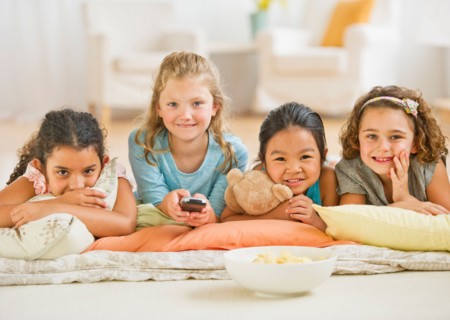 Portrait of girls (6-9) watching TV.