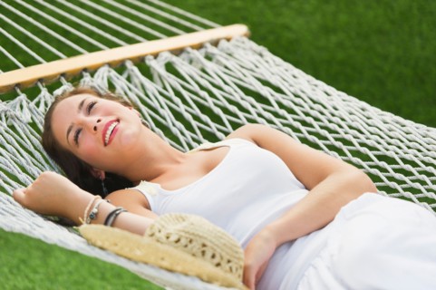 Woman relaxing in hammock.