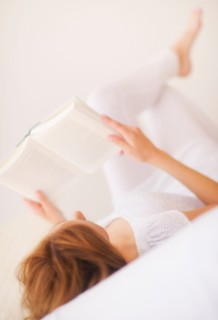 Sensual portrait of young woman reading book. Photo: Daniel Grill