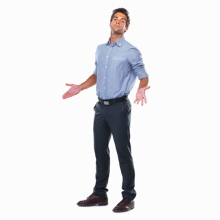 Business man standing with palms out. Photo: momentimages