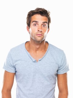 Studio portrait of man with eyes wide open. Photo: momentimages