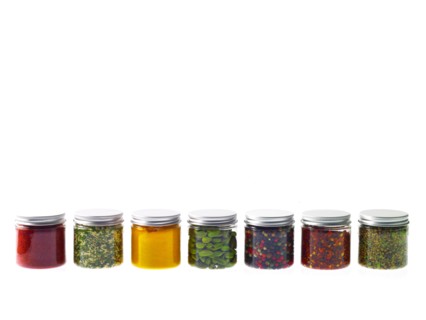 Studio shot of row of jars with spices. Photo : David Arky