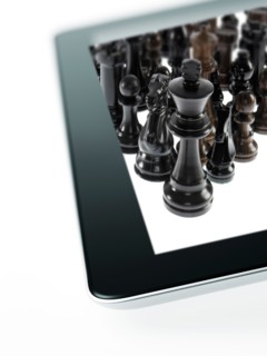 Studio shot of black chess queen and black chess pawns on tablet. Photo : David Arky