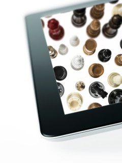 Studio shot of chess pieces on digital tablet. Photo : David Arky