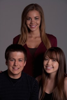 Portrait of teenage boy (16-17) and girl (16-17) with young friend, studio shot. Photo : Rob Lewine
