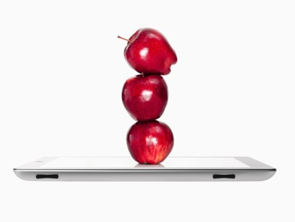 Apples on top of each other on digital tablet, studio shot. Photo : David Arky