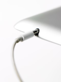 Studio shot of mobile phone with charger. Photo : David Arky