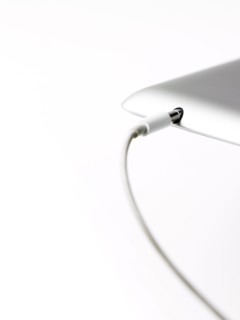 Studio shot of mobile phone with charger. Photo : David Arky