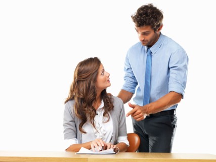 Business woman and business man reading document together. Photo : momentimages