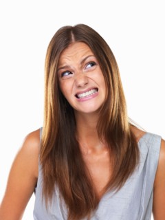 Beautiful woman with fake smile looking away. Photo : momentimages